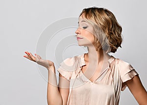 Beautiful woman showing  holding on the palm blank copy space