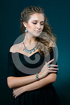 Beautiful woman showing off her jewelery in fashion concept wear