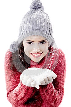 Beautiful woman showing snow on her palm