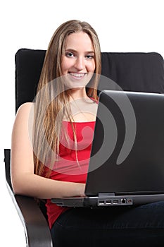 Beautiful woman sitting on an armchair with a laptop
