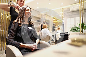 Beautiful woman sitting in the barber chair