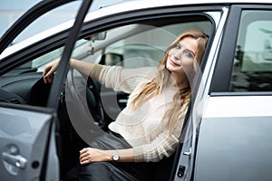 Beautiful woman sitting in car