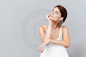 Beautiful woman sitting on the chair and posing