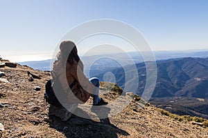 Beautiful woman sitting after hiking during winter or autumn in Catalonia & x28;Turo del Home - Spain