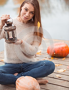 Beautiful woman sitting on the lake shore