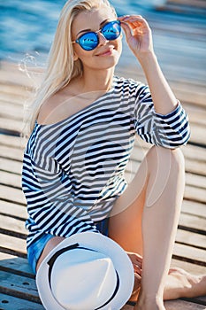 Beautiful woman sitting near the sea