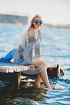 Beautiful woman sitting near the sea