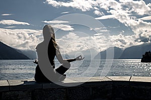 Beautiful woman is sitting on the sea-front, Norway