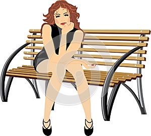 Beautiful woman sitting on the wooden bench photo