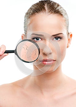 Beautiful woman, skin close up with a magnifying glass