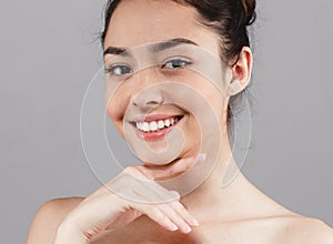 Beautiful woman skincare beauty face teeth smile with handsclo