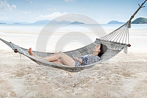 Beautiful woman sleeping on hammock on the beach, Moment from the vocation.