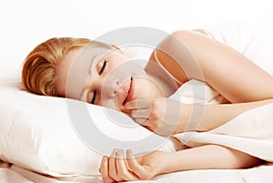 Beautiful woman sleeping and smiles in his sleep in bed