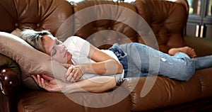 Beautiful woman is sleeping on sofa