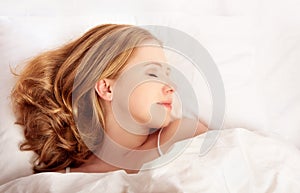 Beautiful woman sleeping in white bed net