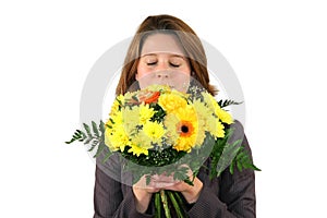 Beautiful woman smelling at a bunch of flowers