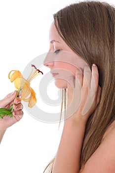 Beautiful woman smelling flower