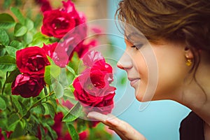 Beautiful woman smelling red roses