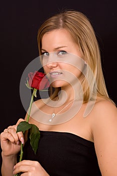 Beautiful woman smelling roses