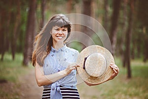 Beautiful woman smile with a canotier hat in summer outdoors