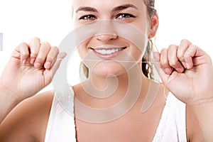 Beautiful woman smile with healthy teeth holding a dental floss in her hands