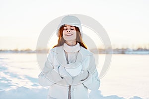 beautiful woman smile Winter mood walk white coat snow in the hands travel
