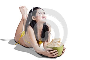 Beautiful woman smiling with coconut drink