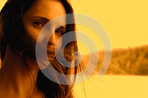 Beautiful woman smiling happy on sunny summer day outside by lake