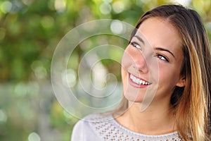 Beautiful woman smiling with a perfect teeth and looking above