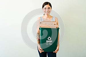 Beautiful woman sorting waste at home