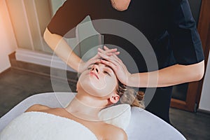 Beautiful woman in spa salon getting facial massage