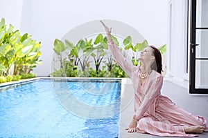 Beautiful woman splashing the water playfully