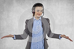 Beautiful woman spreads her hands, earphones on her ears