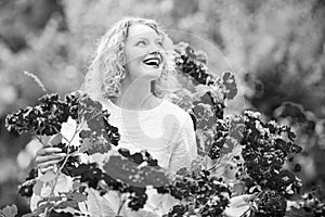 Beautiful woman with spring blooming rose flowers. Young smiling girl enjoys pink rose flowers. Summer time. Happy woman