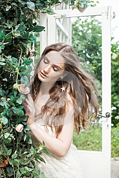 Beautiful Woman in Spring Rose Garden Outdoors