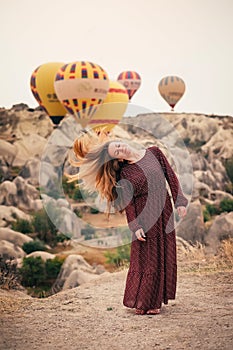 Beautiful woman stand on the cliff and waving hair