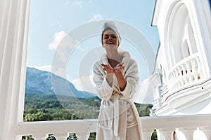 beautiful woman standing on the balcony looking at the mountains vacation in the mountains in summer Relaxation concept
