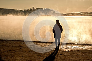 Beautiful woman standing lake of two rivers algonquin national park Canada look sunrise mist in the fog clouded swamp