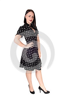 Beautiful woman standing in an pock dot black dress