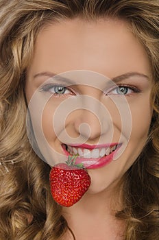 Beautiful woman with strawberry teeth