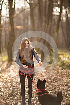Beautiful woman stroking her dog outdoors. Pretty girl playing and having fun with her pet by name Brovko Vivchar