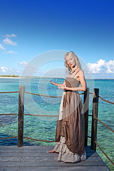 The beautiful woman suggests to swim in the sea.The beautiful woman suggests to swim in the sea.portrait against the tropical sea