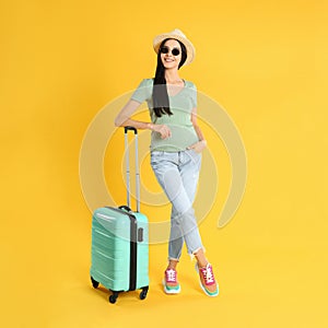 Beautiful woman with suitcase for summer trip on background. Vacation travel