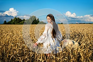 Beautiful woman in the summer wheat field. Summer in countryside