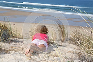 Beautiful woman sunbathing on a beach on the coast