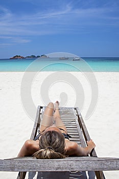 Beautiful woman sunbathing in paradise.