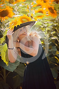 Beautiful woman between sunflowers