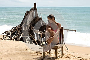 Beautiful woman in sunglasses and red bikini on beach. Fashion look. lady