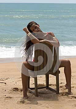 Beautiful woman in sunglasses and red bikini on beach. Fashion look. lady