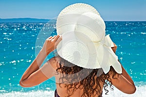 Beautiful woman in sunhat looking view of beach